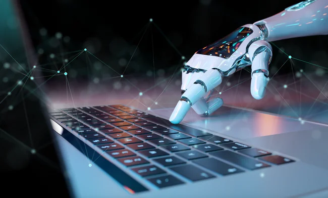 Robotic hand typing on laptop keyboard with digital network nodes in background