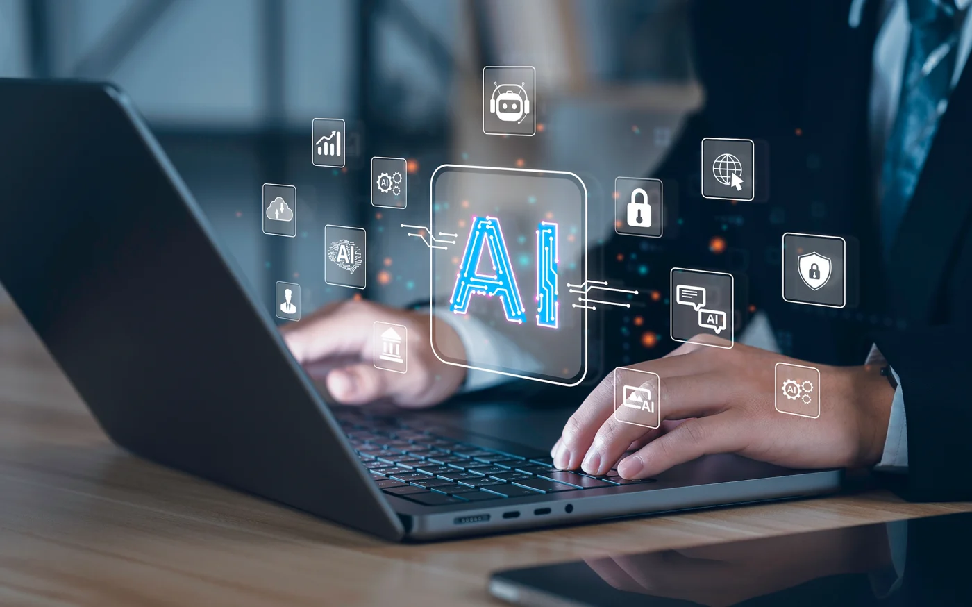 Person using laptop with AI holographic interface and floating tech icons displayed above screen
